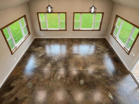 Blackish Malayan Buff and Seagrass acid stained concrete floor in a loft style room