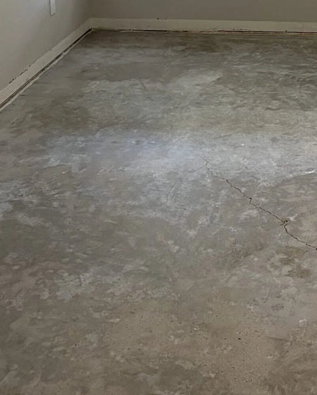 Image of a room with bare concrete floor, prior to acid staining
