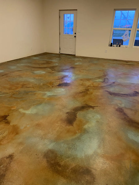A photo displaying the final look of the stained concrete floor, exhibiting a beautiful mix of colors