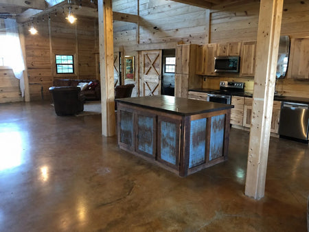 Shifting Sand and Malayan Buff acid stained concrete floor in a rustic barndominium kitchen
