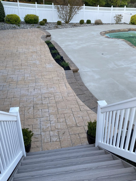 Faded brown, stamped concrete floor before the application of stain