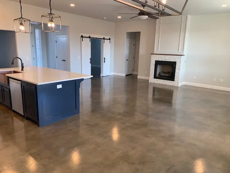 Living room concrete floor beautifully stained with Stormy Gray, Driftwood, and Charcoal Vibrance Dye