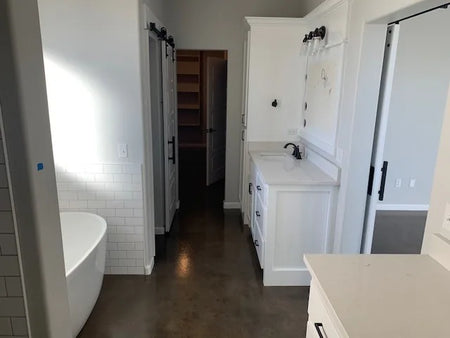 Concrete bathroom floor dyed with a blend of Stormy Gray, Driftwood, and Charcoal Vibrance Dye