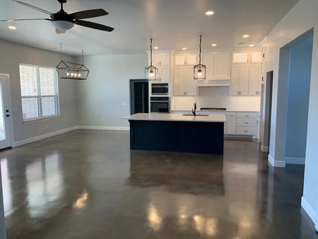 Concrete kitchen floor showcasing a modern mix of Stormy Gray, Driftwood, and Charcoal Vibrance Dye