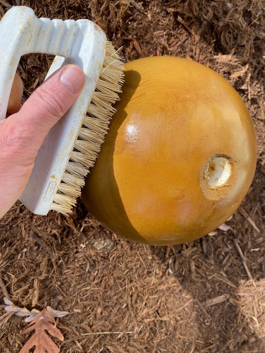 Neutralizing an acid stained concrete fountain sphere