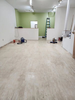 Artistic woodgrain effect achieved by skillfully troweling and burnishing the textured top coat