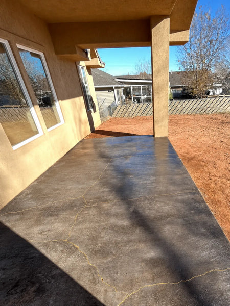 Broom-finish concrete patio transformed with Black Antiquing Stain, gold-painted cracks, and satin acrylic sealer