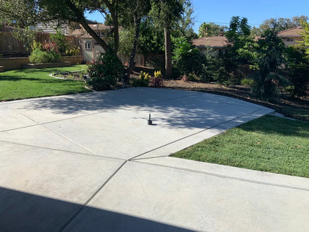 Unstained 400-square-foot broom-finish concrete patio before applying Cola EverStain Acid Stain