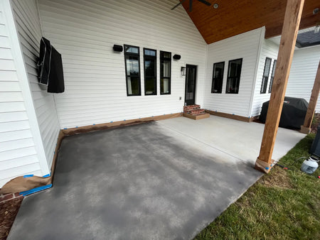 Silver Gray Antiquing Stain being applied to a broom-finish covered concrete patio