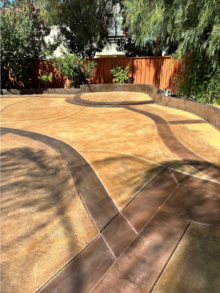 Backyard concrete patio refinished with Cafe Royale base color and Aztec Brown borders, creating a rich, uniform tone
