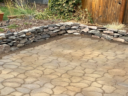 Cobblestone-pattern concrete patio colored with Cafe Royale, Olive, and Charcoal Antiquing Stain