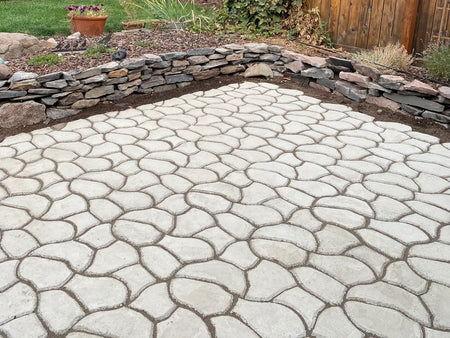 Unstained cobblestone-pattern concrete patio before applying Cafe Royale, Olive, and Charcoal Antiquing Stain