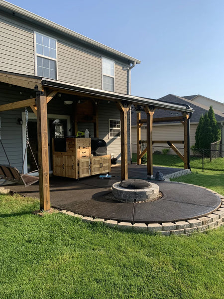 The patio, post-staining, with a harmonized blend of Coffee Brown and Blackish EverStain, diminishing the distinction between the old and new concrete