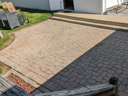 Faded 15-year-old concrete paver patio before applying Crimson and Eagle Gray Portico Stain