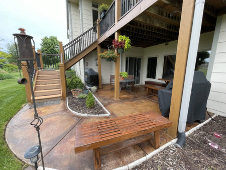 Transformed round patio showcasing a rich blend of Malayan Buff, Desert Amber, and English Red acid stains, complementing the refinished redwood furniture