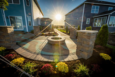 Round concrete patio acid stained with EverStain™ Seagrass, Blackish, and Malayan Buff using a wet-on-dry layering technique for a multi-colored outdoor finish
