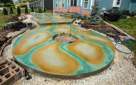 The round concrete patio design was enhanced with Blackish and Malayan Buff acid stains applied inside the Seagrass streaks