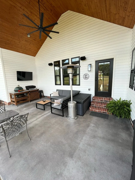Image showcasing the revitalized concrete covered patio with Silver Gray Antiquing stain, now adorned with outdoor furniture, highlighting the transformed space ready for enjoyment