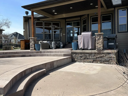 Smooth concrete patio poured in 2012 with its original dark red integral color faded to light pink