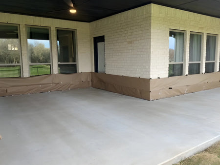 Plain 433-square-foot covered smooth concrete patio masked and prepared for Black Antiquing Stain