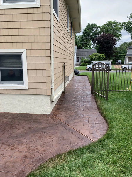 Patched Stamped Concrete Patio After Applying Aztec Brown Antiquing Stain