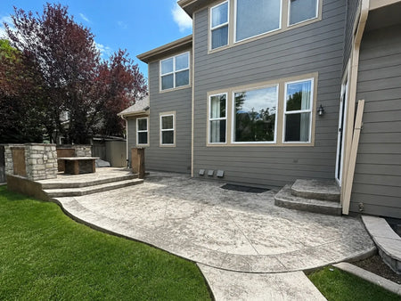 Faded stamped concrete patio with discoloration and efflorescence before restoration
