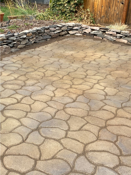 Stamped concrete patio finished with Cafe Royale, Olive, and Charcoal Antiquing™ Stains, featuring rich, layered tones that mimic natural stone
