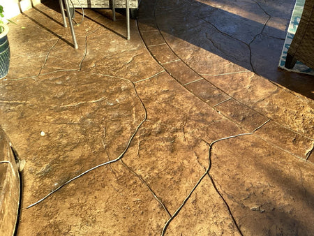 Stamped concrete patio after EasySeal Gloss application with richer brown color and enhanced texture
