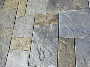 Close-up image highlighting the intricate textures and the harmonious blend of Silver Gray, Light Charcoal, and Tweed Antiquing stains on the slate-stamped concrete patio