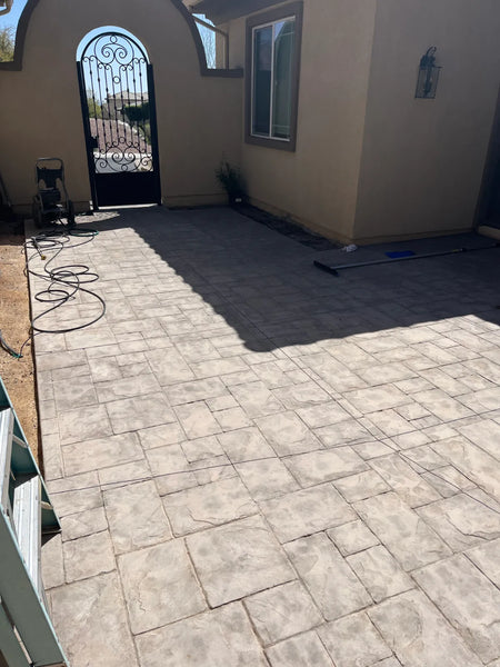 Faded, weathered stamped concrete patio before recoloring with Antiquing stain