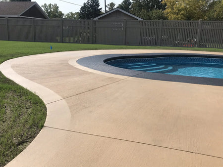 easytint stained broomed concrete pool deck khaki charcoal coping