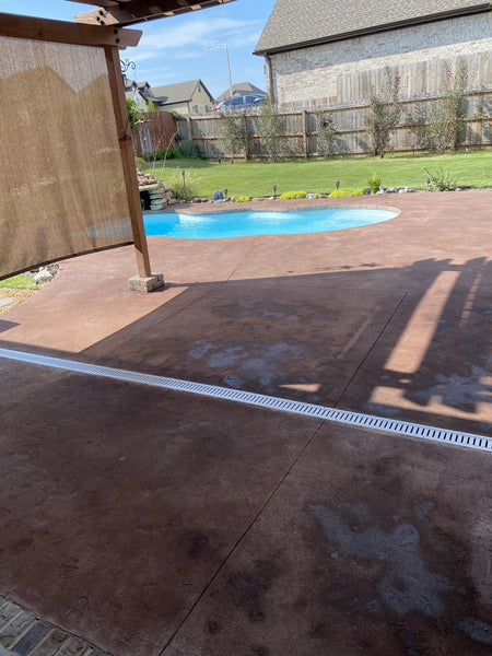 Applying Aztec Brown Antiquing stain to a stamped concrete pool deck