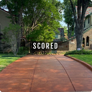 Driveway with 'SCORED' sign in front of a house