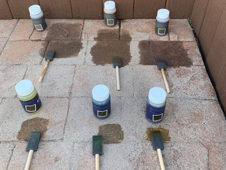 Testing different Antiquing Stain colors from a trial kit on faded stamped concrete