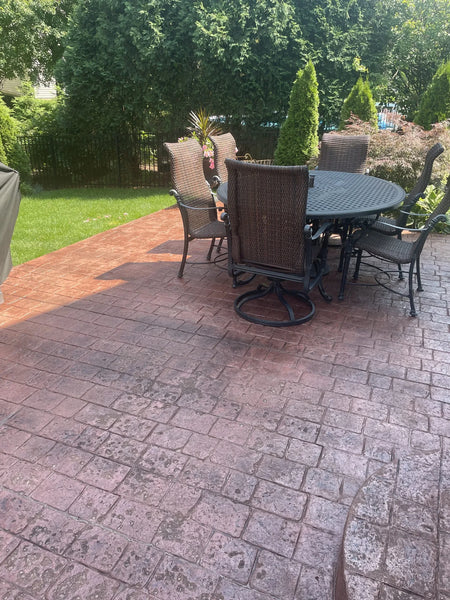 Refreshed stamped concrete surface, now sporting a rich Aztec Brown