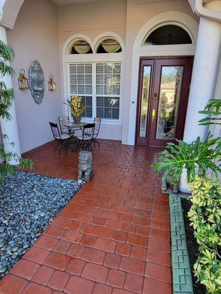 Stunning walkway featuring crimson red stained concrete pavers and fern green stained concrete pavers used to frame the walkway