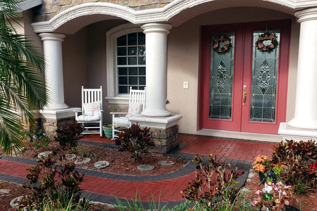 Front entry walkway with Milano Red concrete pavers and Charcoal border leading to a covered porch