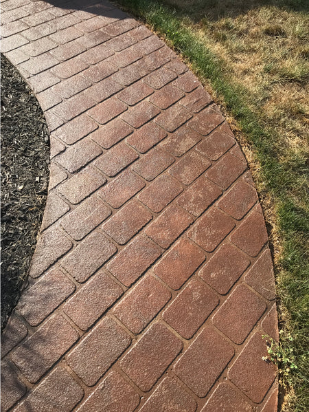 Paver walkway refreshed with Cafe Royale Portico™ Paver Stain, showcasing rich brown tones and a smooth sealed finish