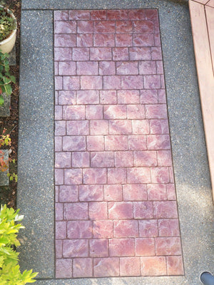 Patio floor with rich Cinnabar staining, sealed to perfection, showcasing enhanced color vibrancy