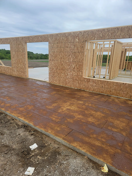 Wood-plank stamped concrete patio being stained with Coffee Brown EverStain acid stain