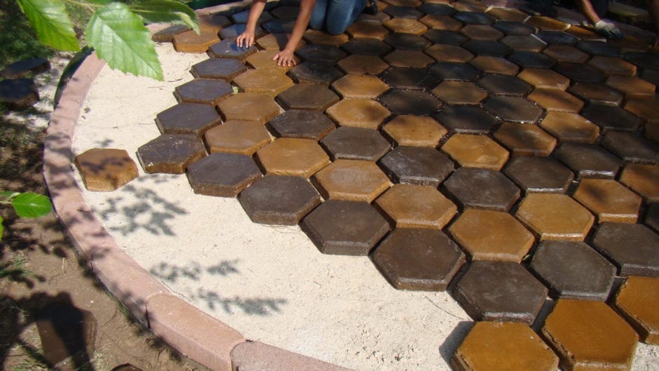 Hexagonal concrete pavers in shades of brown and tan, forming a unique garden path