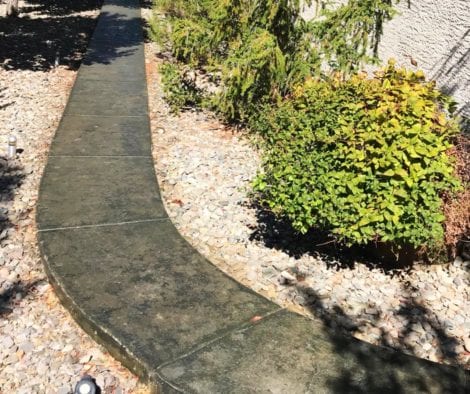 Concrete Walkway Stained with Olive and Black Antiquing Stains. Sealed with Satin Finish Solvent Based Acrylic Concrete Sealer
