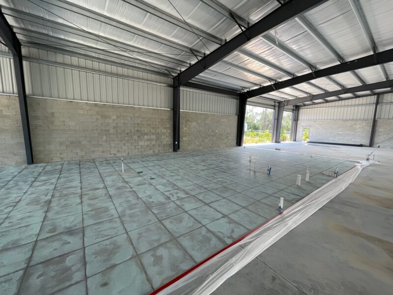 Photo of a concrete floor displaying the subtle Azure Blue base color after applying and allowing the lighter acid stain to activate.