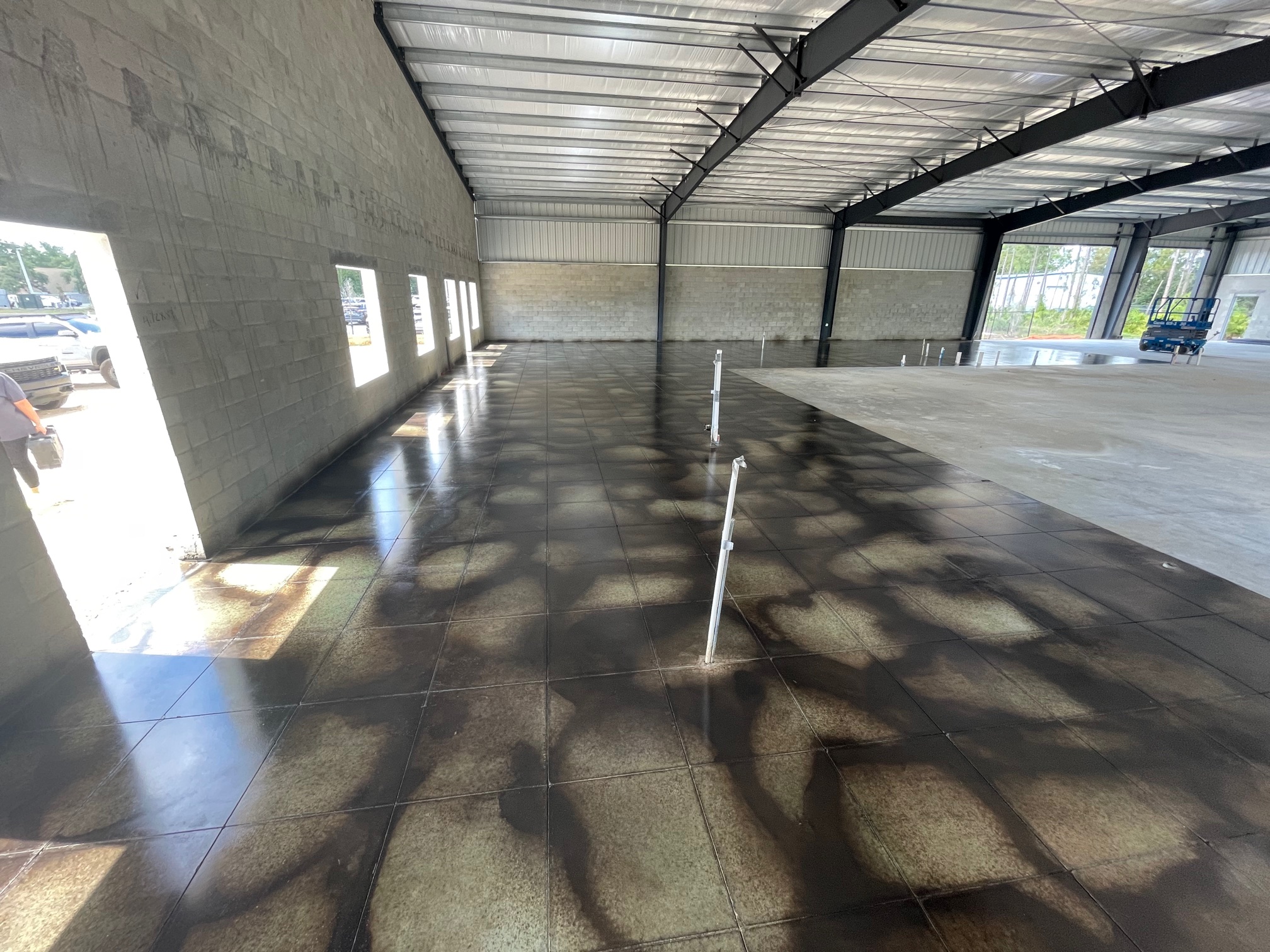 Photo of a finished concrete floor, with a glossy and polished surface, showcasing the final outcome of the acid staining process.