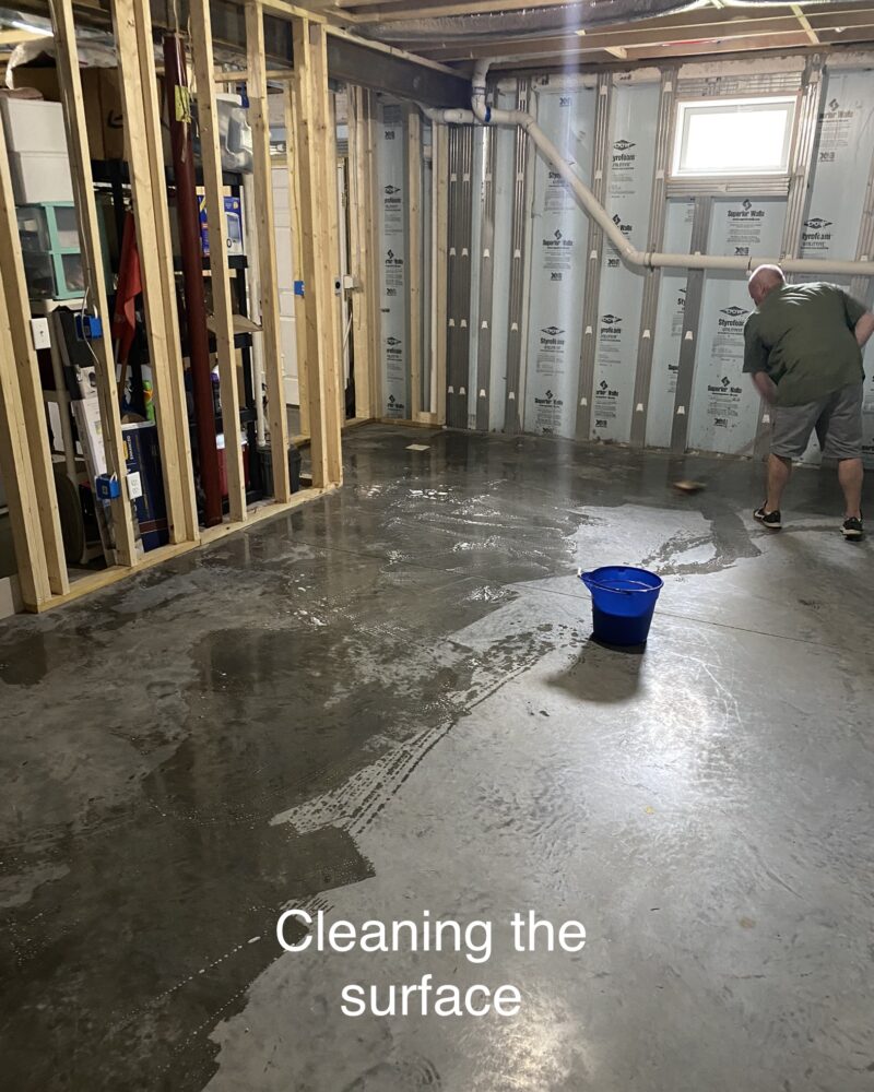 Man neutralizing and rinsing CitrusEtch solution from a concrete floor with a mop