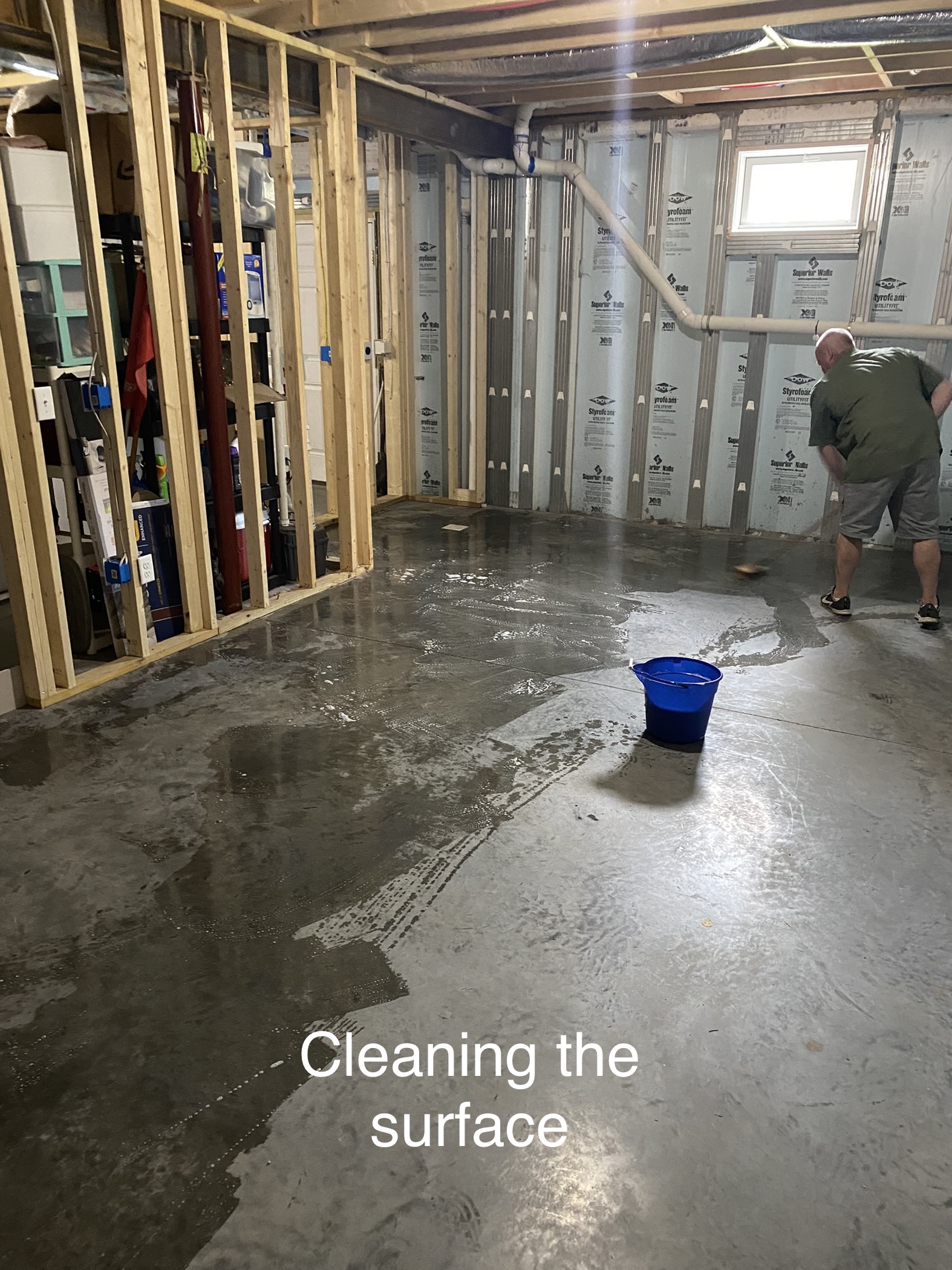 Man neutralizing and rinsing CitrusEtch solution from a concrete floor with a mop