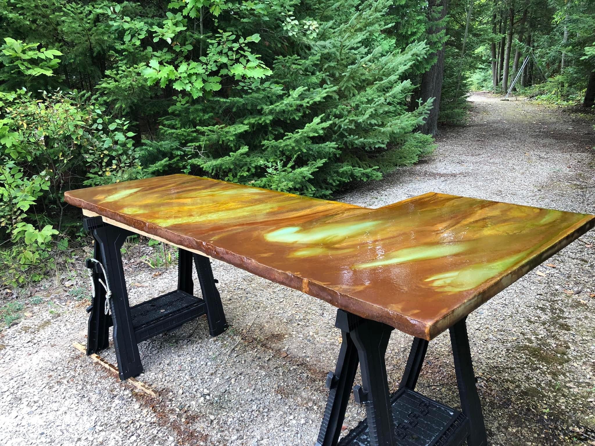 Poured in place concrete countertop with a mottled finish, created using wet-on-wet technique and featuring acid stain colors of coffee brown, seagrass, and desert amber.