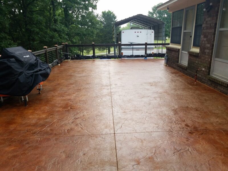Acid stained stamped and scored concrete patio