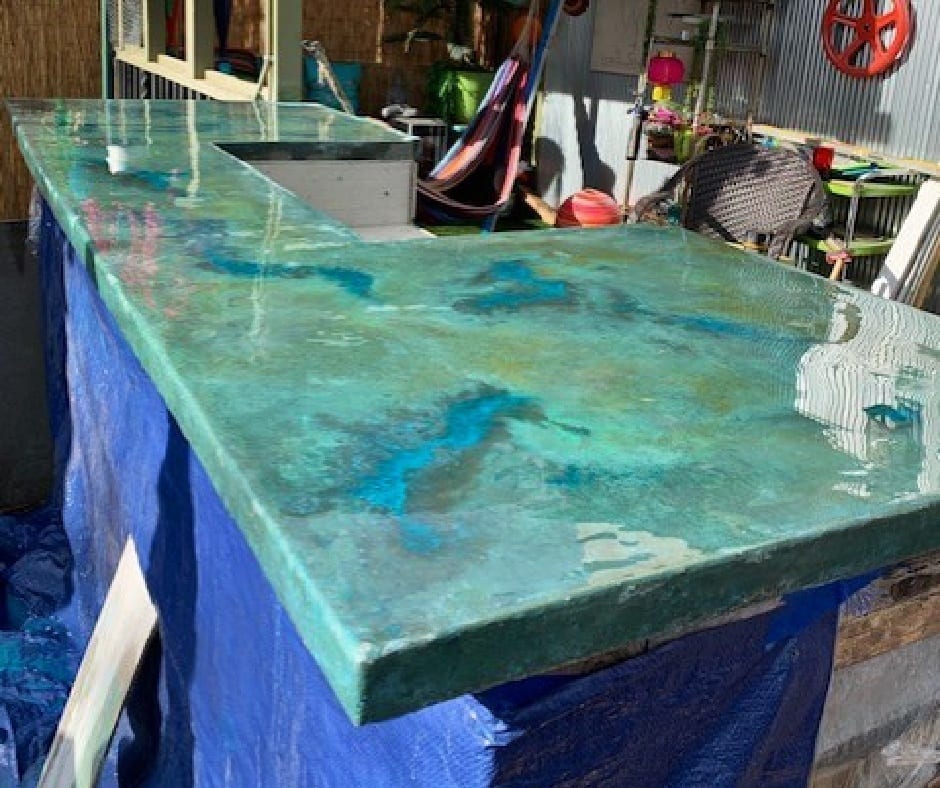 Beautiful mottled Azure Blue EverStain acid stained outdoor kitchen countertop