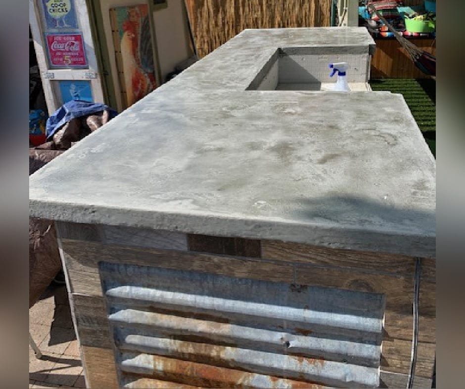 Concrete countertop made with a plywood based and a skimcoat of gray concrete overlay